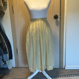 Long blue and yellow pleated skirt.